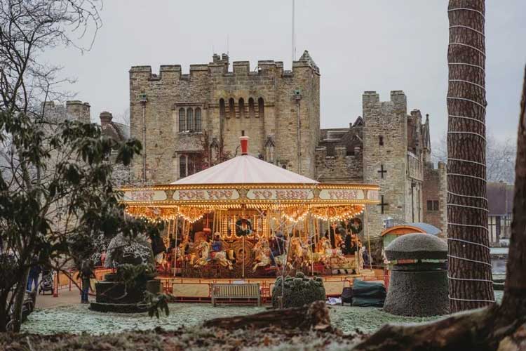 A carousel in front of Hever Castle at Christmas