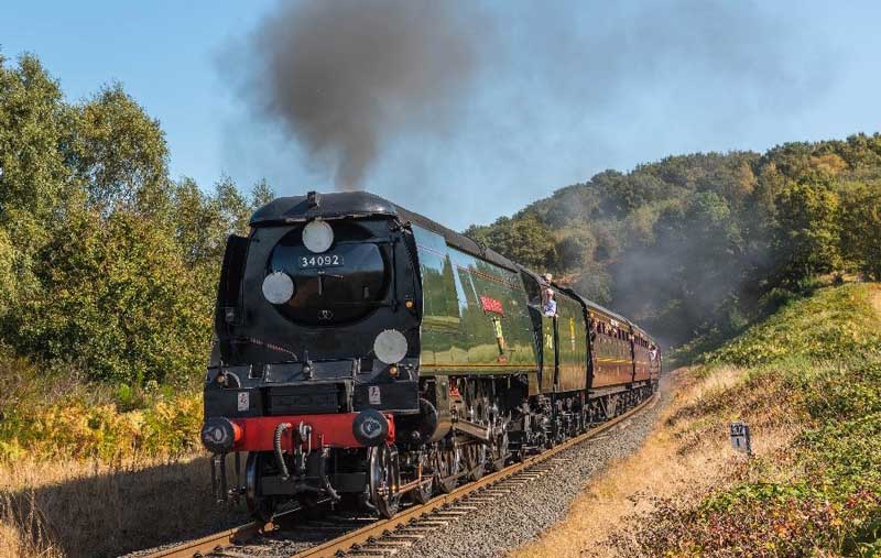 A steam train going through the countryside