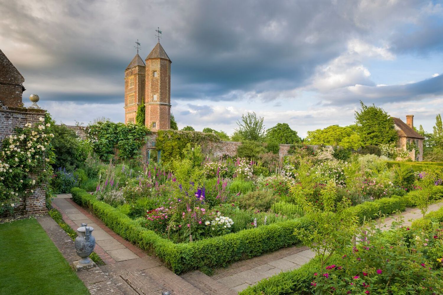 A wide angle view of Sissinghurst Castle and its gardens filled with beautiful flowers