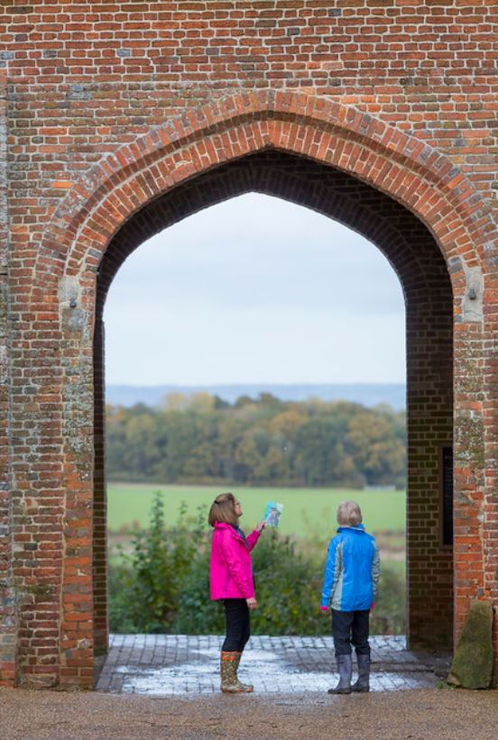 two walkers under an arch at Sissinghurst Castle