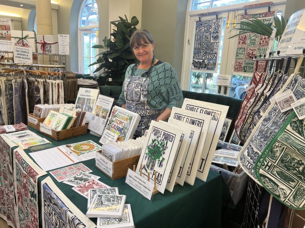 A lady selling goods at a Christmas Fair