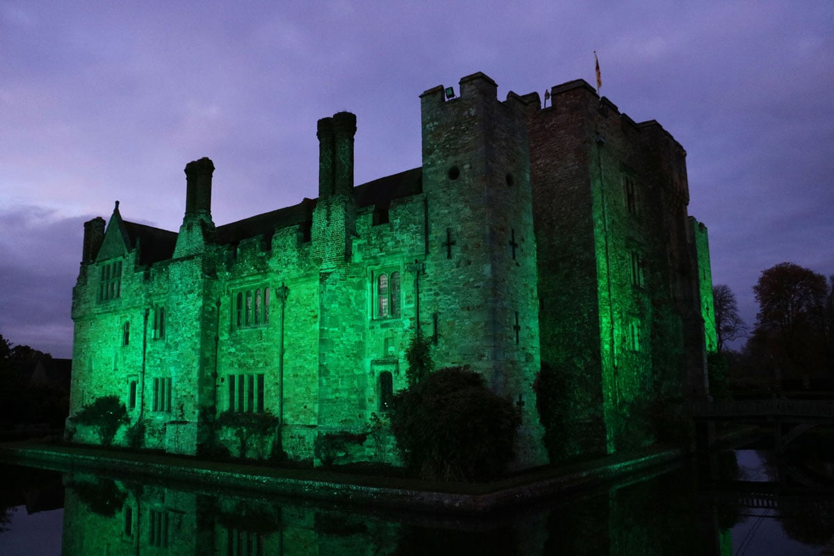 Hever Castle illuminated by a green light for Halloween