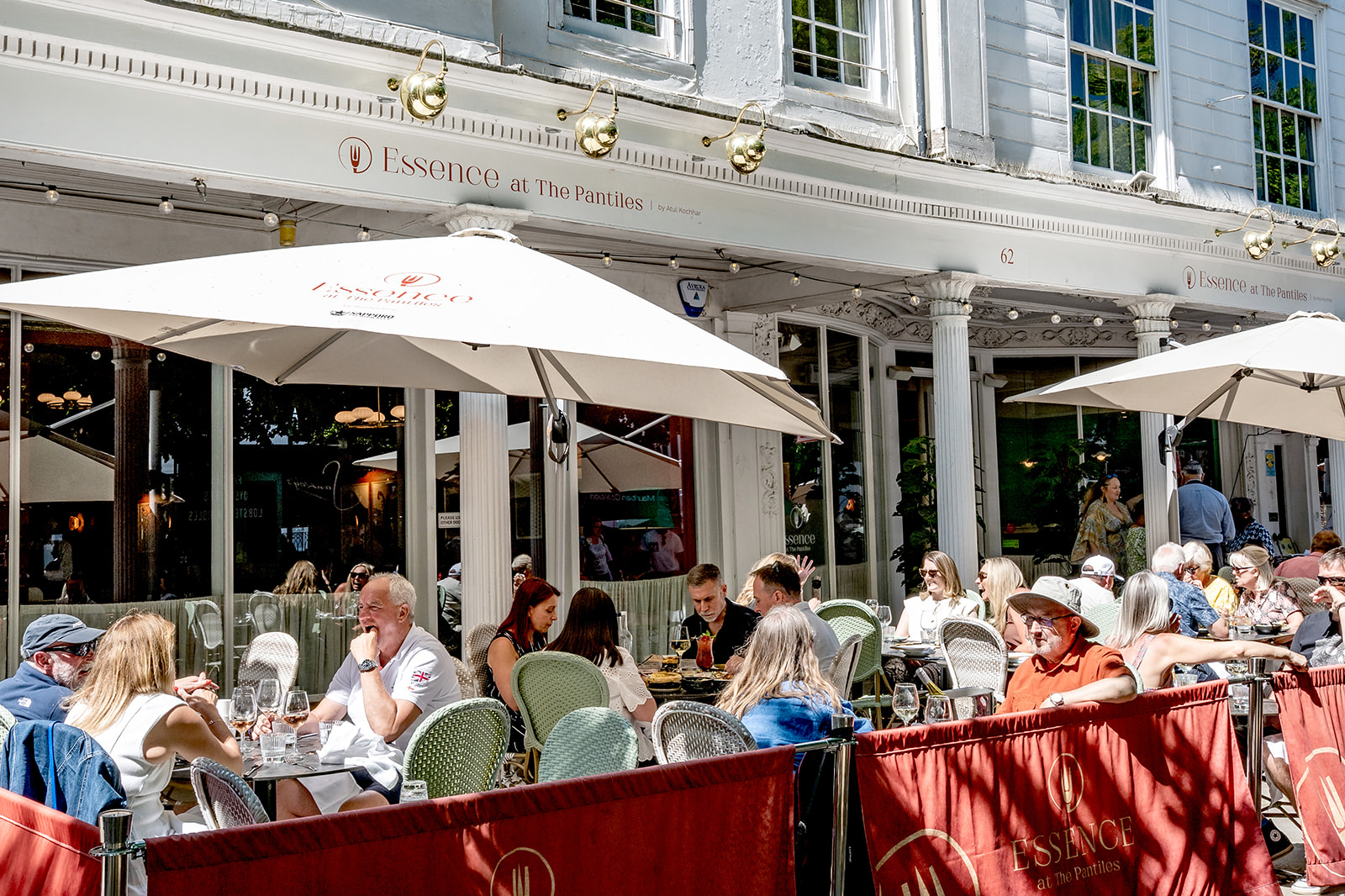 Essence | LitFest/World of Flavour Front of restaurant with outdoor seating under umbrellas