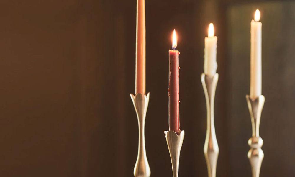 Anthropologie - a candle display of four candles